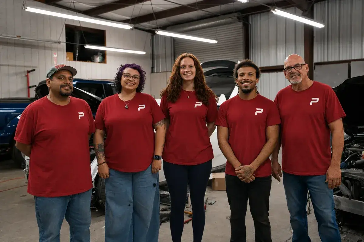 The Podium Body Works collision repair team standing together in the shop