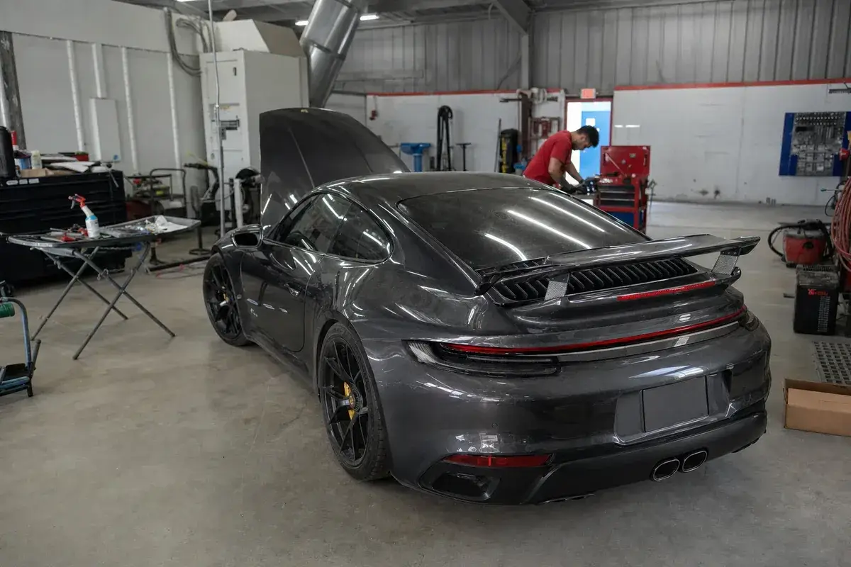 An exotic sports car in the repair bay at Podium Body Works in Liberty Hill, Texas