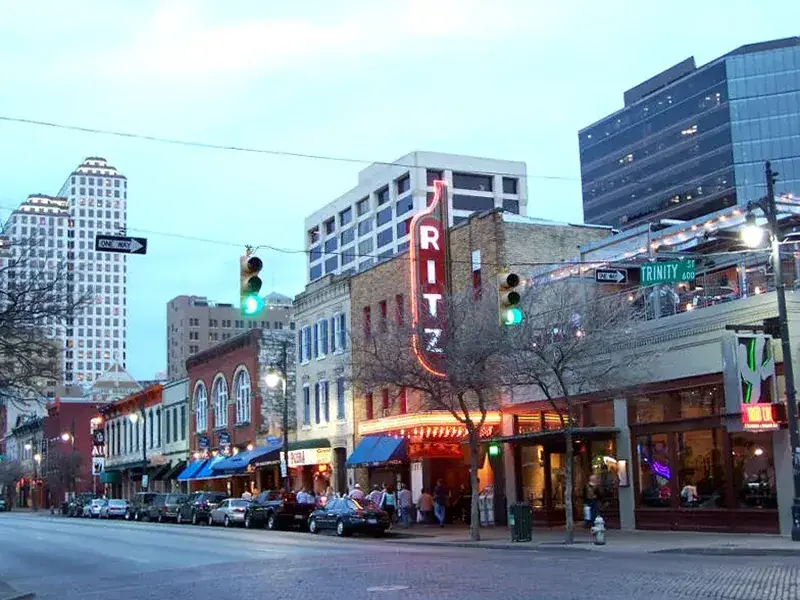 A downtown street scene in the greater Austin area at dusk, part of the region Podium Body Works serves