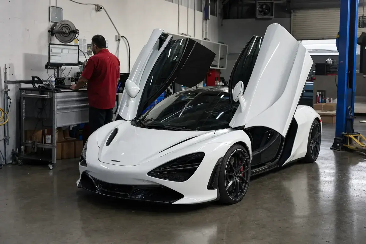 A McLaren parked in a spotless service bay at Podium Body Works in Liberty Hill, Texas