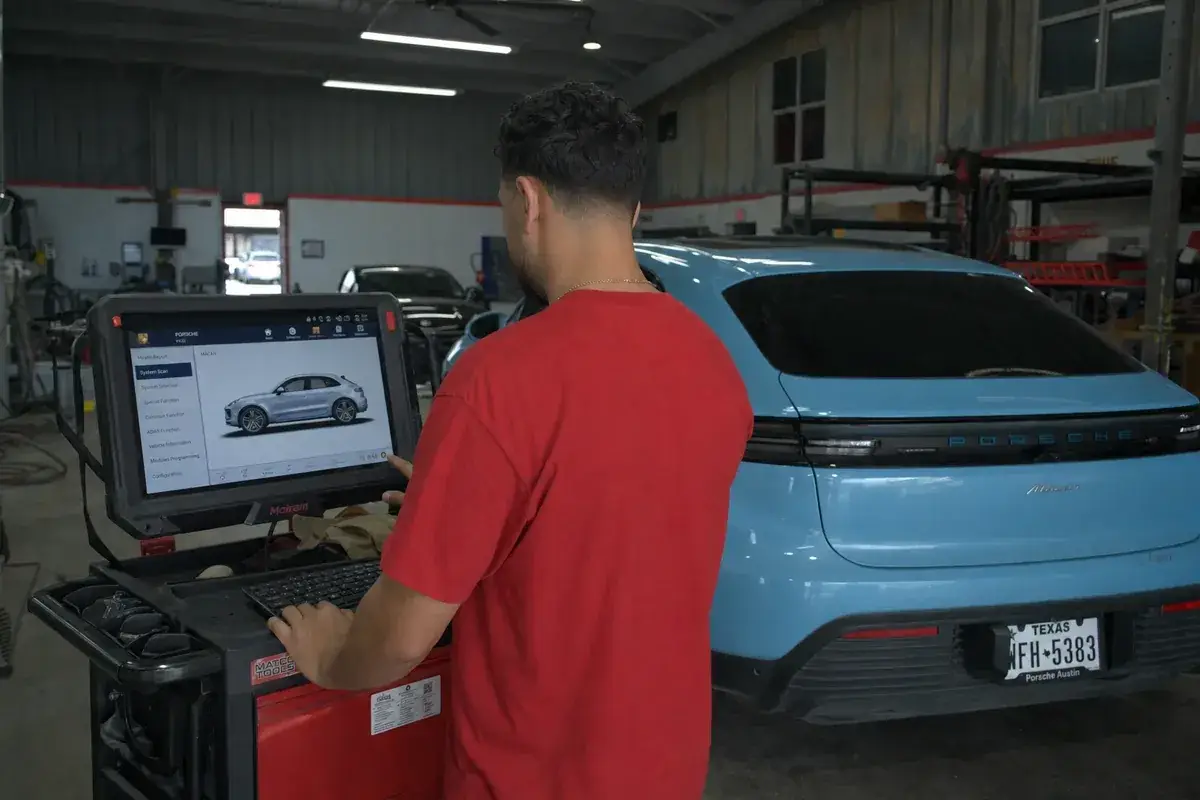 A technician running a calibration at the scan-tool cart at Podium Body Works in Round Rock, Texas