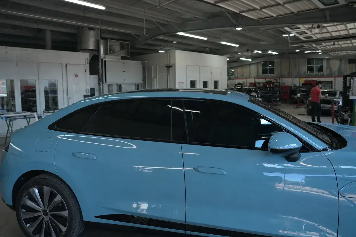 Freshly tinted side glass of a sedan, clean and even at Podium Body Works in Round Rock, Texas